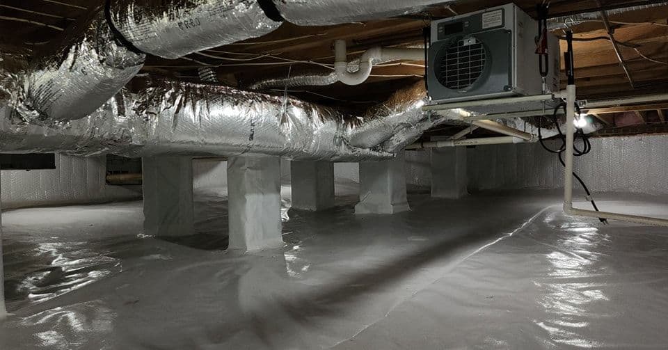 Crawl space with silver ductwork and a dehumidifier, featuring a sealed white vapor barrier.