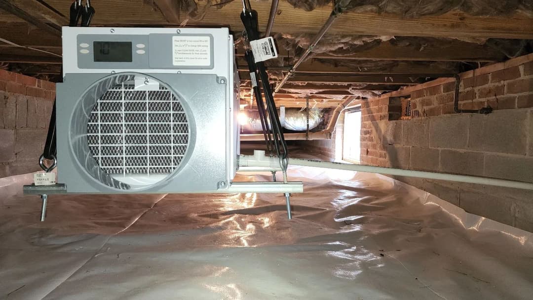 Sump pump installed in a crawl space for moisture control and flood prevention.