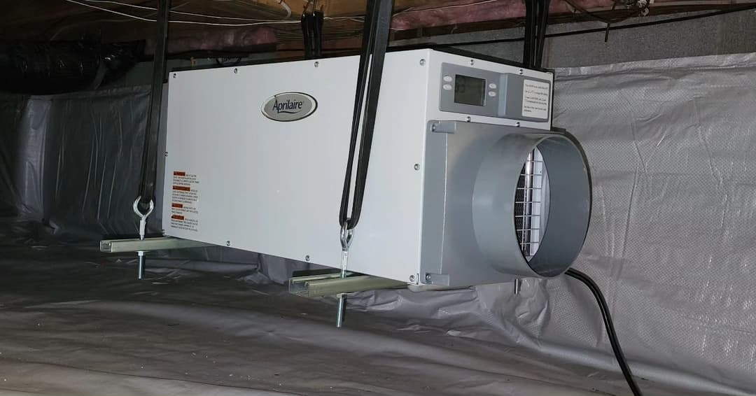 AirMate dehumidifier installed in a basement for moisture control and air quality improvement.
