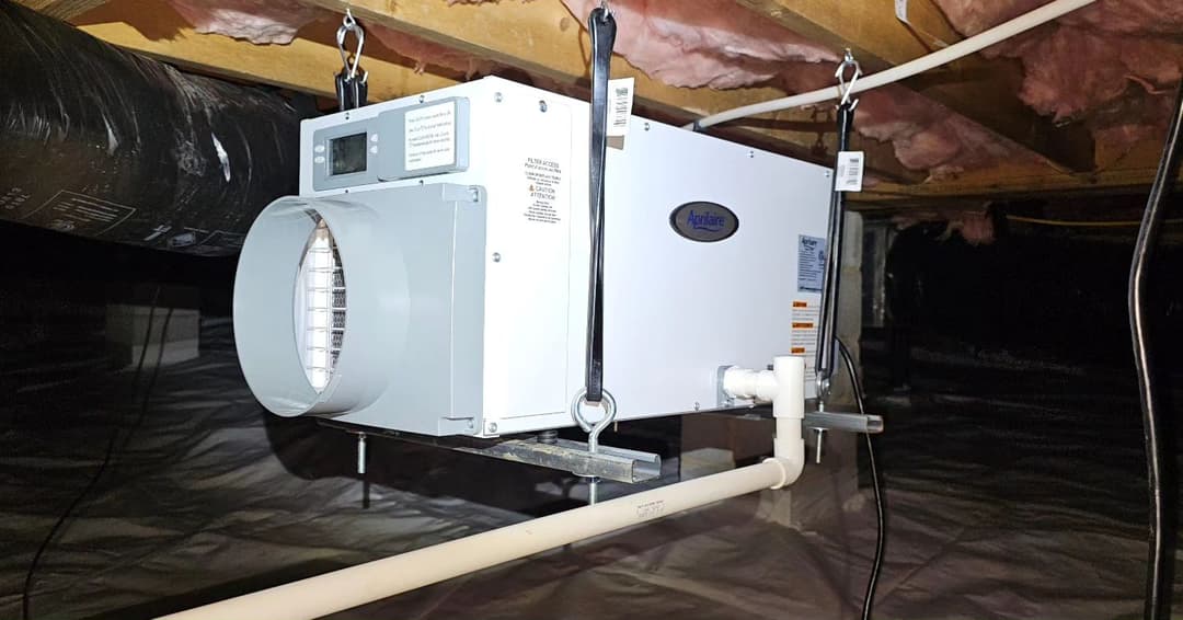 Air exchange system installed in a basement with ductwork, promoting ventilation and air quality.