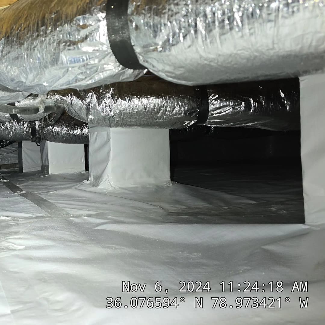 Ductwork and encapsulated space in a crawl space with reflective insulation.